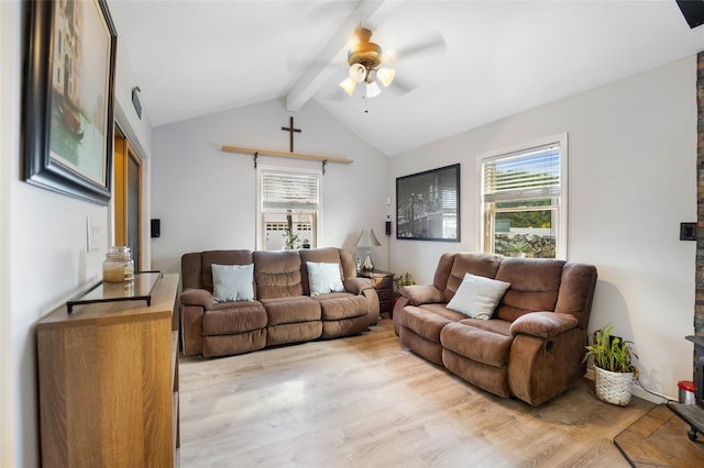 living room featuring ceiling fan, vaulted ceiling with beams, light hardwood / wood-style flooring, and a healthy amount of sunlight