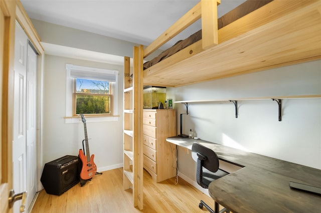 office with light hardwood / wood-style flooring