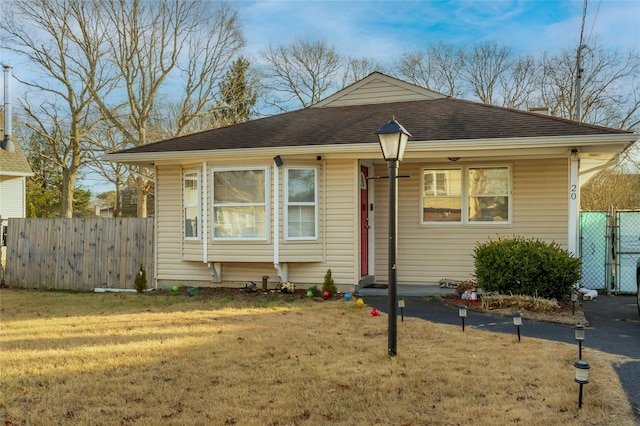 bungalow-style home featuring a front yard