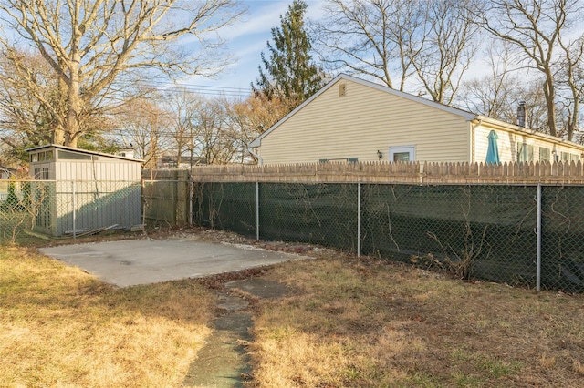 view of yard with a shed and a patio