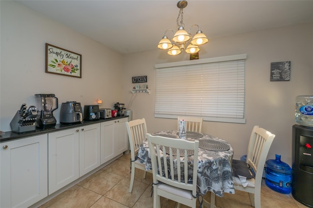 tiled dining room featuring an inviting chandelier