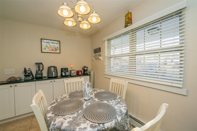 dining area featuring light tile patterned flooring, a baseboard heating unit, and a chandelier