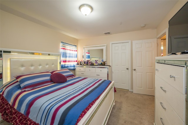 bedroom with light colored carpet