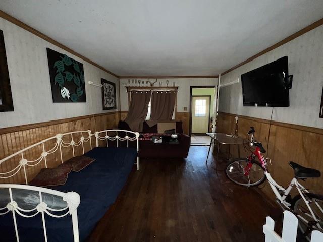 bedroom with crown molding and hardwood / wood-style flooring