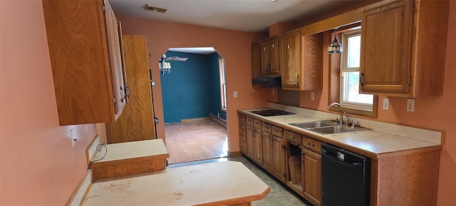 kitchen featuring sink, a wealth of natural light, a baseboard heating unit, and black appliances