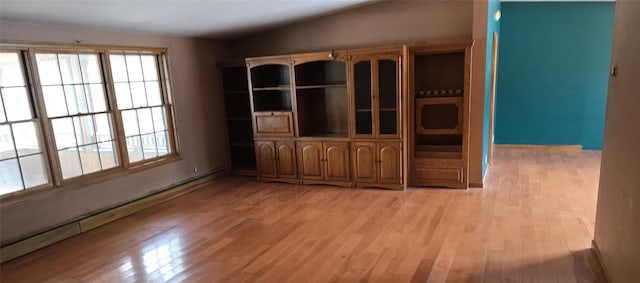 interior space with lofted ceiling, light hardwood / wood-style flooring, and a baseboard radiator