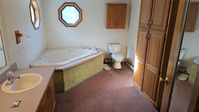 bathroom with vanity, tiled bath, toilet, and baseboard heating