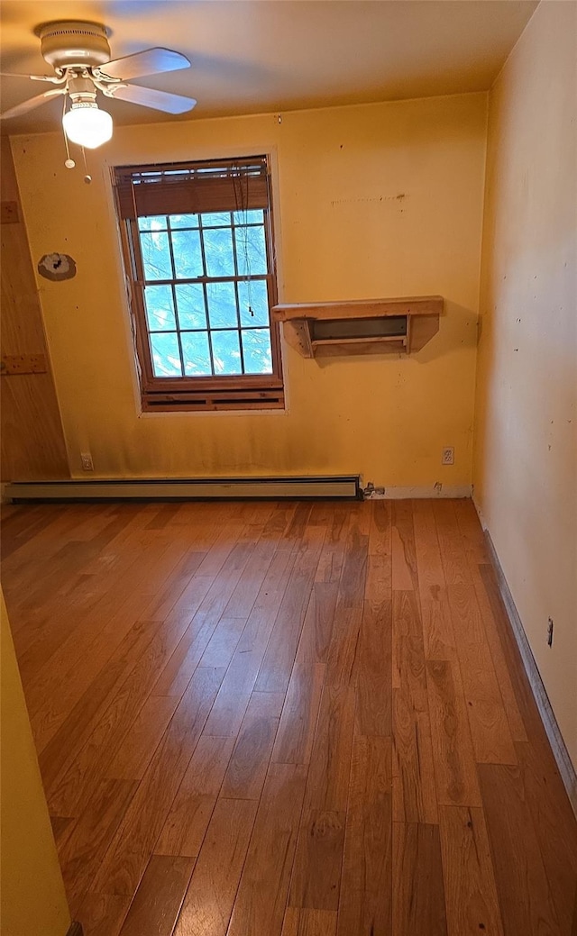 unfurnished room featuring light wood-type flooring, a baseboard radiator, and ceiling fan