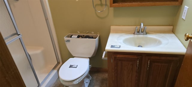 bathroom with tile patterned floors, vanity, toilet, and a shower with door