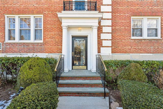 doorway to property featuring brick siding