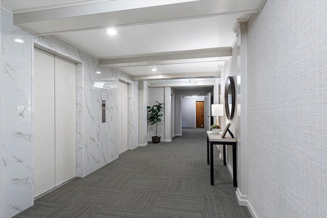 hallway with beamed ceiling and tile walls