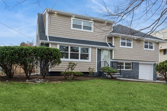 view of front of home with a front lawn and a garage