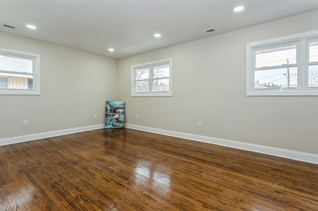 spare room with dark wood-type flooring