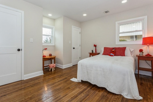 bedroom with dark hardwood / wood-style flooring