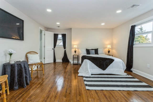 bedroom featuring dark wood-type flooring and multiple windows