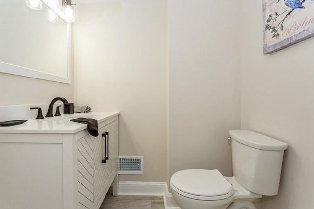 bathroom featuring toilet and vanity