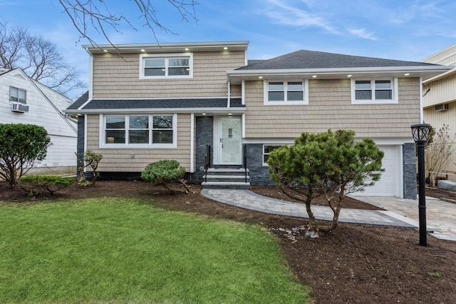 view of front of house with a front yard and a garage