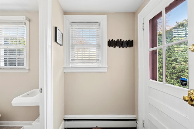 doorway featuring baseboard heating and a healthy amount of sunlight