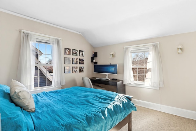 bedroom with carpet floors and lofted ceiling