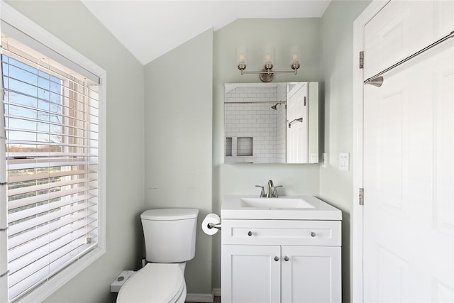 bathroom with vanity, toilet, and lofted ceiling