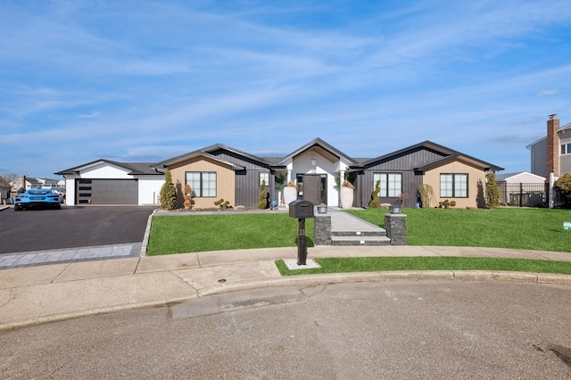 view of front of house with a garage and a front lawn