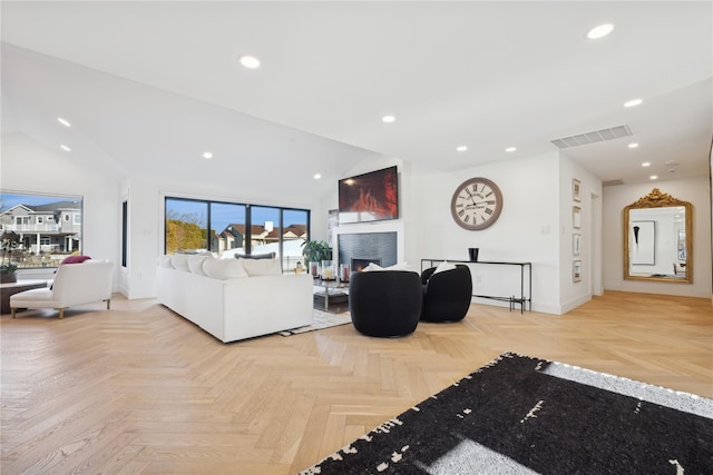 living room featuring lofted ceiling and light parquet floors