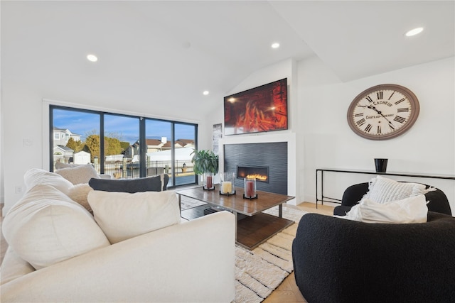 living room featuring vaulted ceiling and light hardwood / wood-style floors