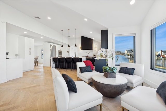 living room featuring lofted ceiling and light parquet floors