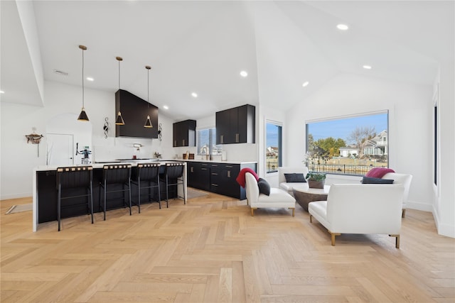 living room with high vaulted ceiling and light parquet floors