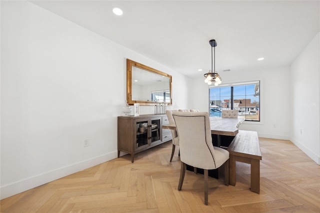 dining area featuring an inviting chandelier and light parquet floors