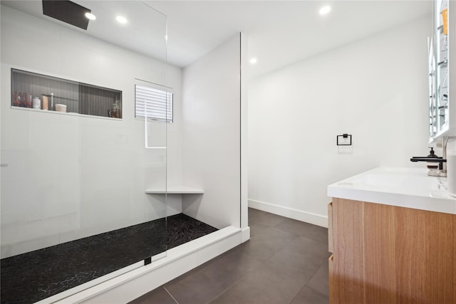 bathroom featuring a shower and vanity