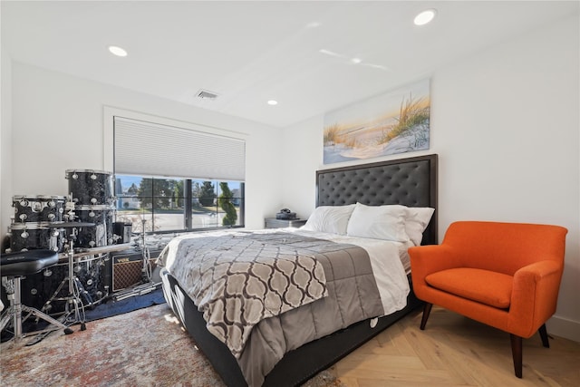 bedroom with light parquet flooring