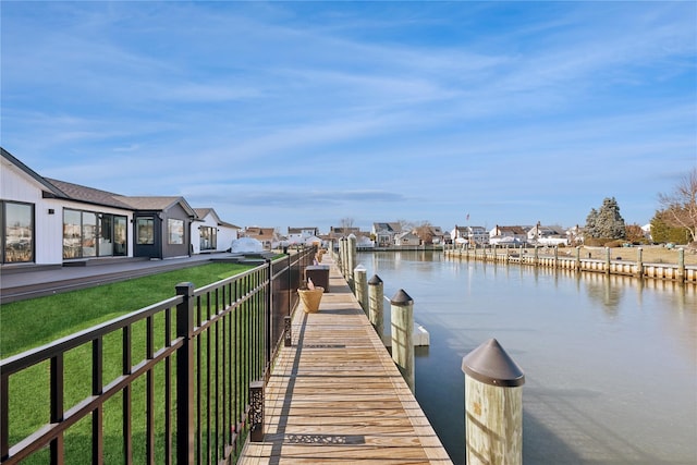 view of dock featuring a water view and a lawn