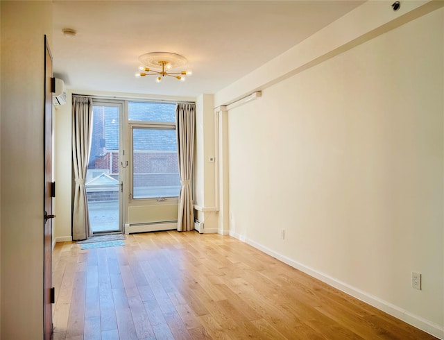 doorway to outside featuring baseboard heating, light hardwood / wood-style floors, a wall mounted air conditioner, and a chandelier