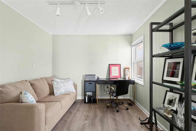 office with hardwood / wood-style floors and a textured ceiling