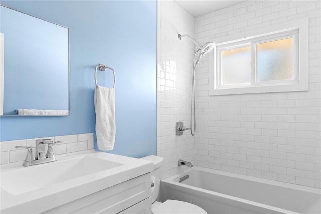 full bathroom with tiled shower / bath combo, toilet, and vanity