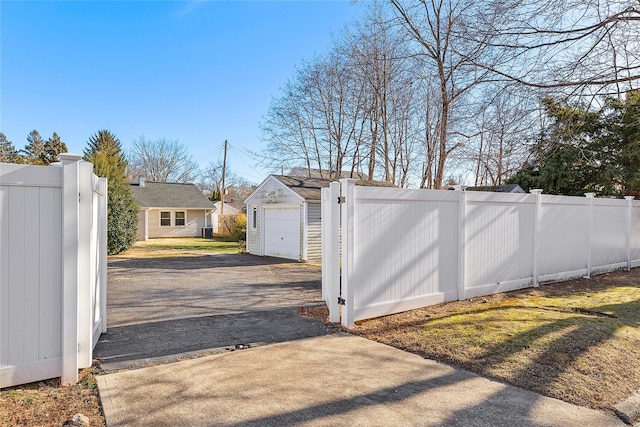 view of gate with an outbuilding