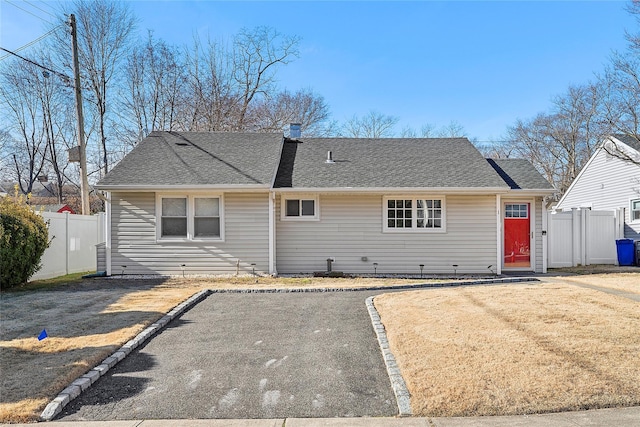 rear view of property featuring a yard