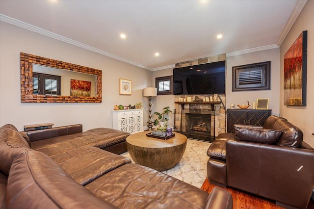 living room with crown molding, a fireplace, and hardwood / wood-style floors