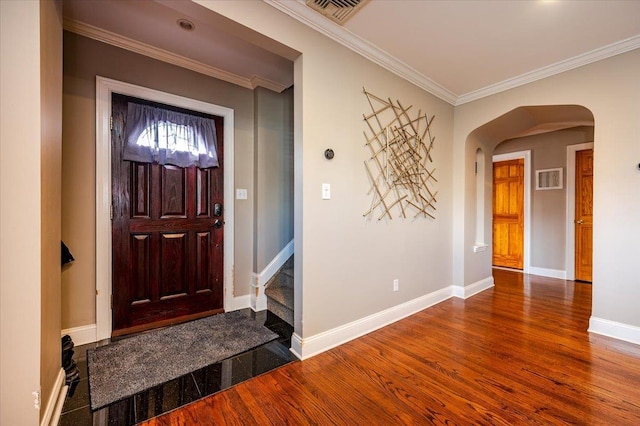 entryway featuring crown molding and hardwood / wood-style floors