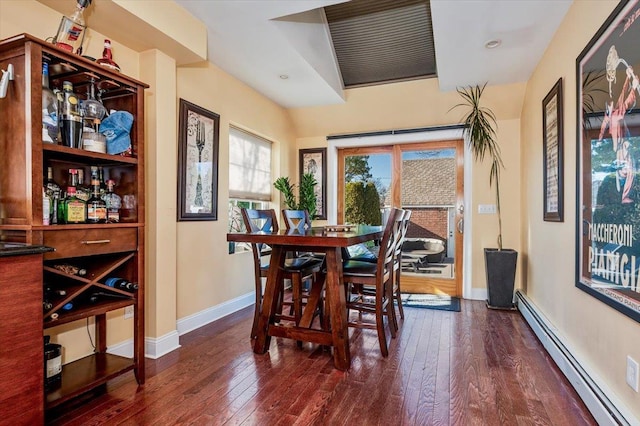 dining space with a baseboard radiator and dark hardwood / wood-style floors