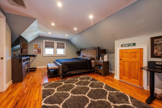 bedroom featuring lofted ceiling and hardwood / wood-style floors