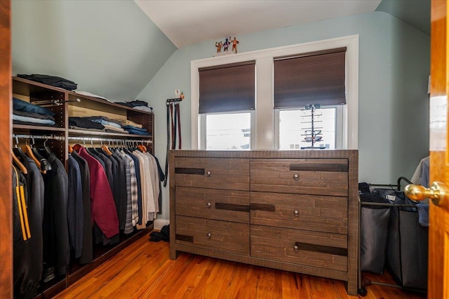 walk in closet with lofted ceiling and hardwood / wood-style floors