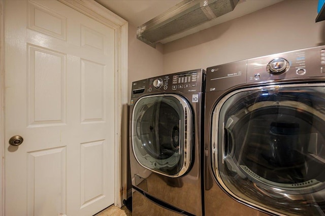 clothes washing area with washing machine and clothes dryer