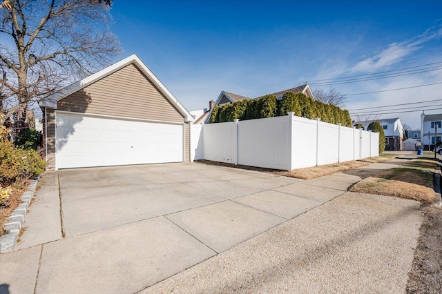 view of property exterior with a garage and an outdoor structure