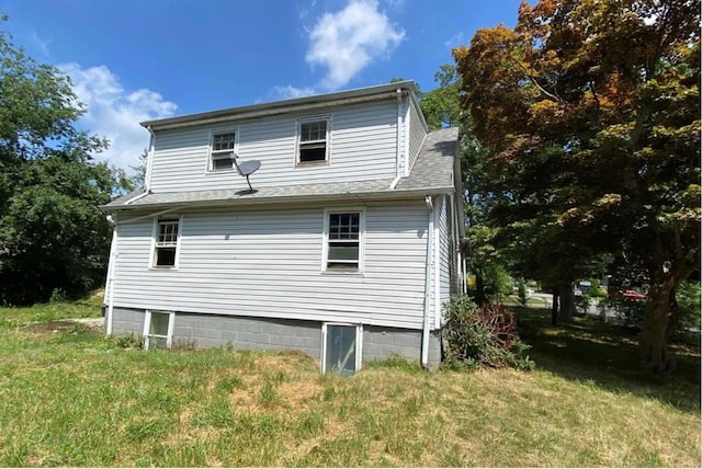 back of house with a yard