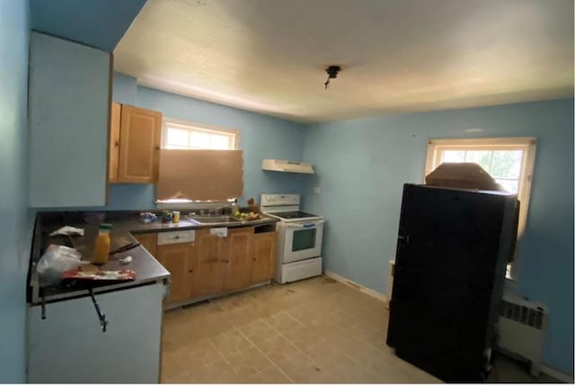 kitchen with white electric range, sink, light brown cabinets, and radiator heating unit