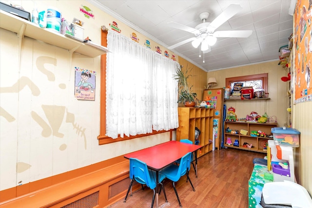 playroom with hardwood / wood-style flooring, ceiling fan, and ornamental molding