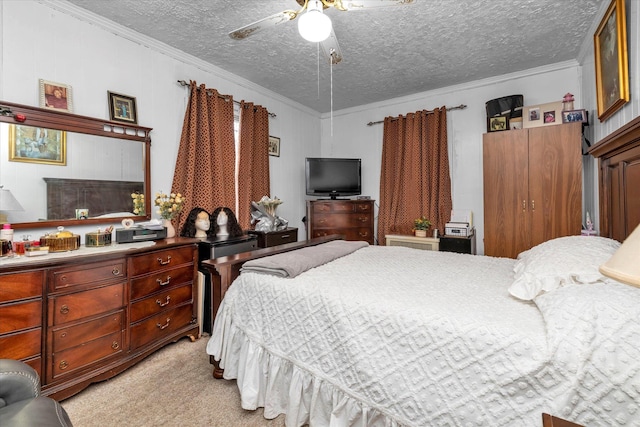 bedroom with ceiling fan, light colored carpet, ornamental molding, and a textured ceiling