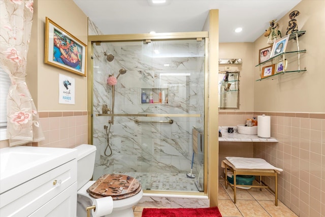 bathroom featuring tile patterned flooring, a shower with door, toilet, and tile walls